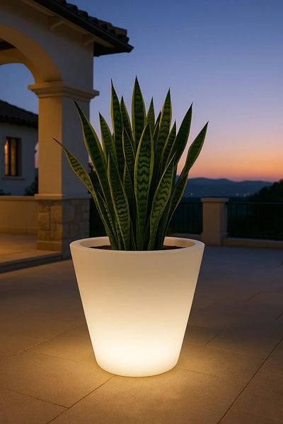 Pot Cono LED Vondom éclairé sur une terrasse au crépuscule