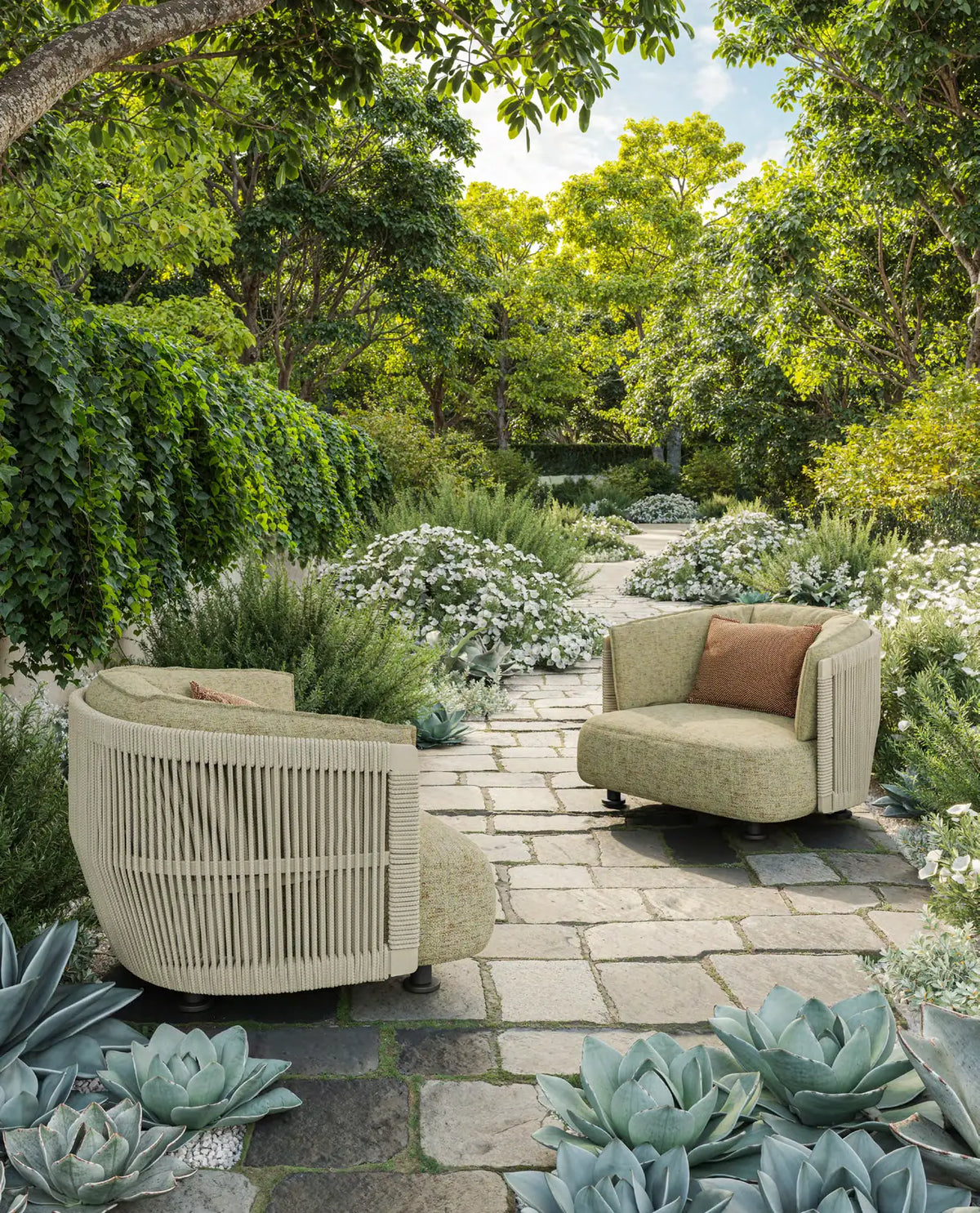 Deux fauteuils Serra Vondom dans l'allée d'un jardin de pierre, entourés d'agaves